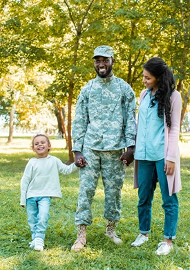 African American solider in the park with his young daughter and wife.