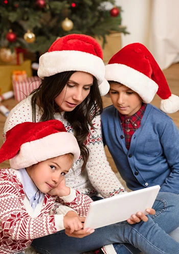 Mom teaching kids about their new tablet on Christmas.