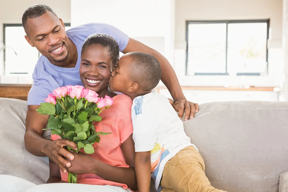 Dad and son give mom flowers for Mother's Day.