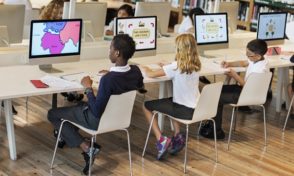 Group of students working on computers in the school library.