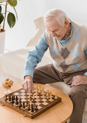 Well dressed Elderly man playing chess with himself.