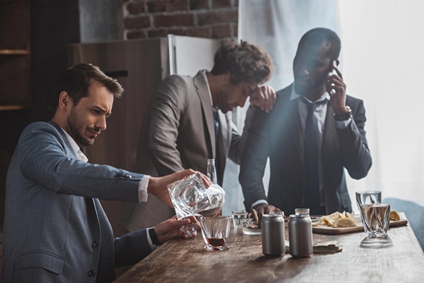 Group of well dressed men in a bar drinking.