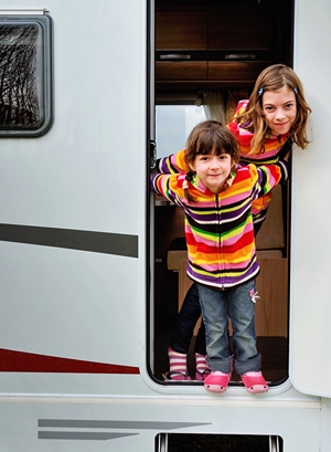 Brother and Sister Standing in RV Doorway