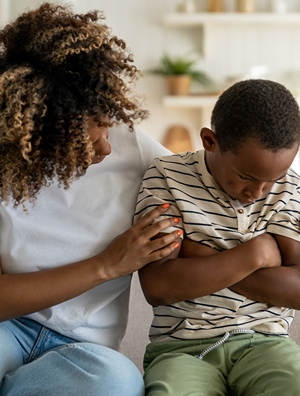 Mother holding son who is experiencing grief.