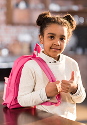 African American girl with pick back back giving a thumbs up!