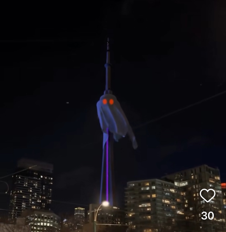 CN Tower with red eyes peering through a white sheet.