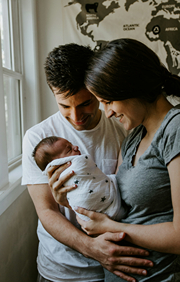 Father and Mother holding their precious new born baby,