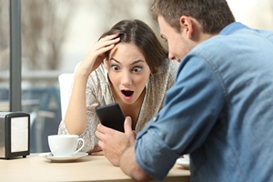 Excited Parents Looking at Phone