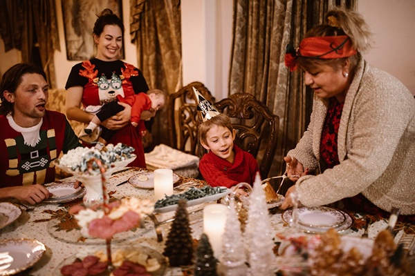 Happy family gather around the dinner table to Christmas.