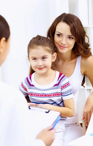 Girl in Chiropractor's office with her mother.