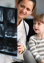 Little girl looking at her x-rays with female doctor.