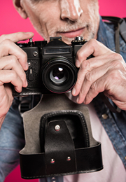 A male photography taking a picture of the viewer.