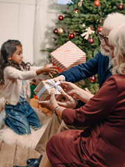 Family opening gifts around the Christmas Tree