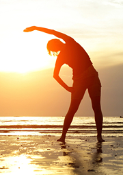 Silhouette of woman yoga position in the sun.