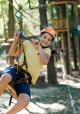 Boy having a blast on a zip line.