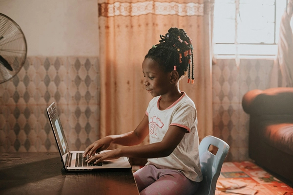 A Nigerian girl working on her laptop at home. 