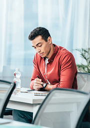 Male college student working at a desk.