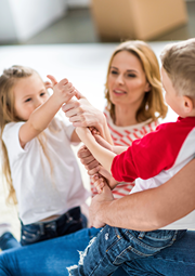 Mom playing a game with her son and daughter.