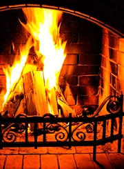 Home fireplace burns brightly.