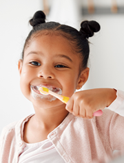 Close up of girl vigorously brushing her teeth.