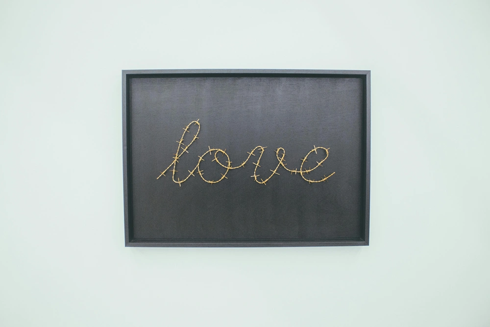 The word love creatively written and framed as a wall poster.