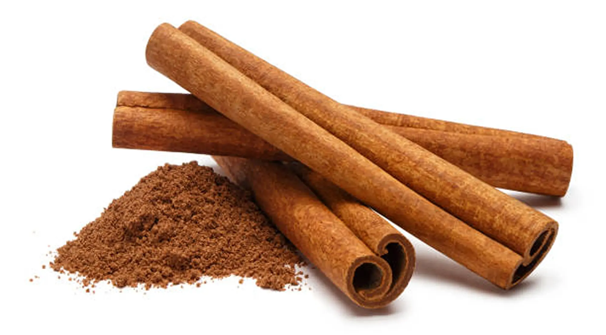 Ground cinnamon in pile beside stacked cinnamon sticks.