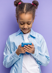 Smiling girl interacting via social media on her smartphone.