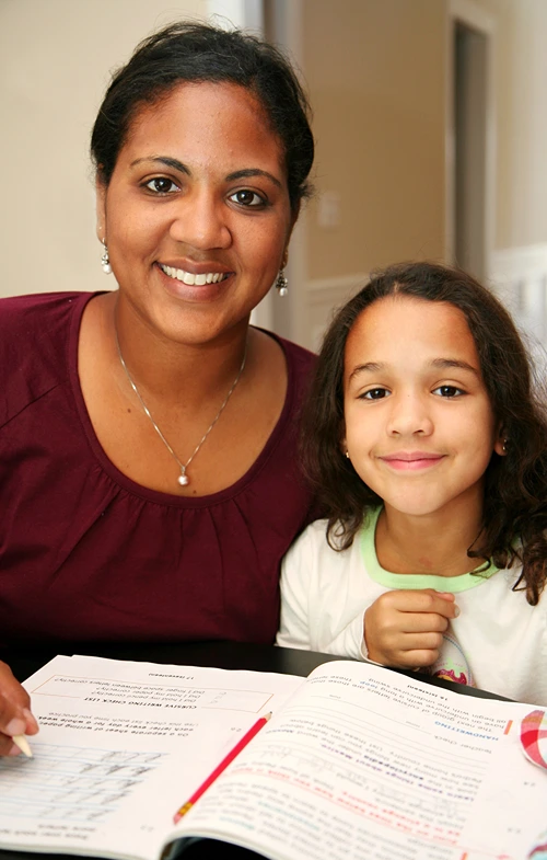 Homeschooling mother teaching daughter math.