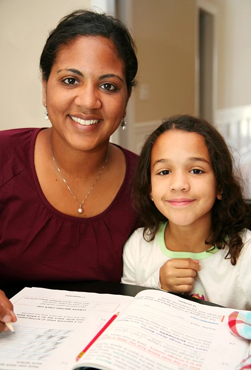 Homeschooling mother teaching daughter math.