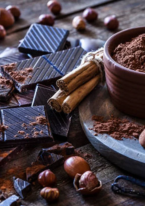 Candy next to cinnamon sticks and bowl of ground cinnamon.