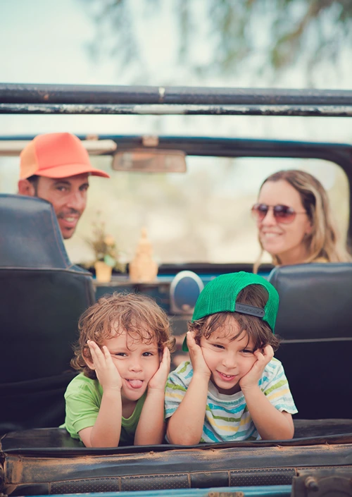 Two parents and two kids in a jeep ready to explore.