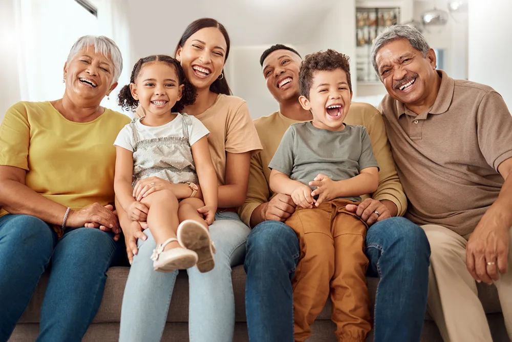 A multigenerational family gather on a couch